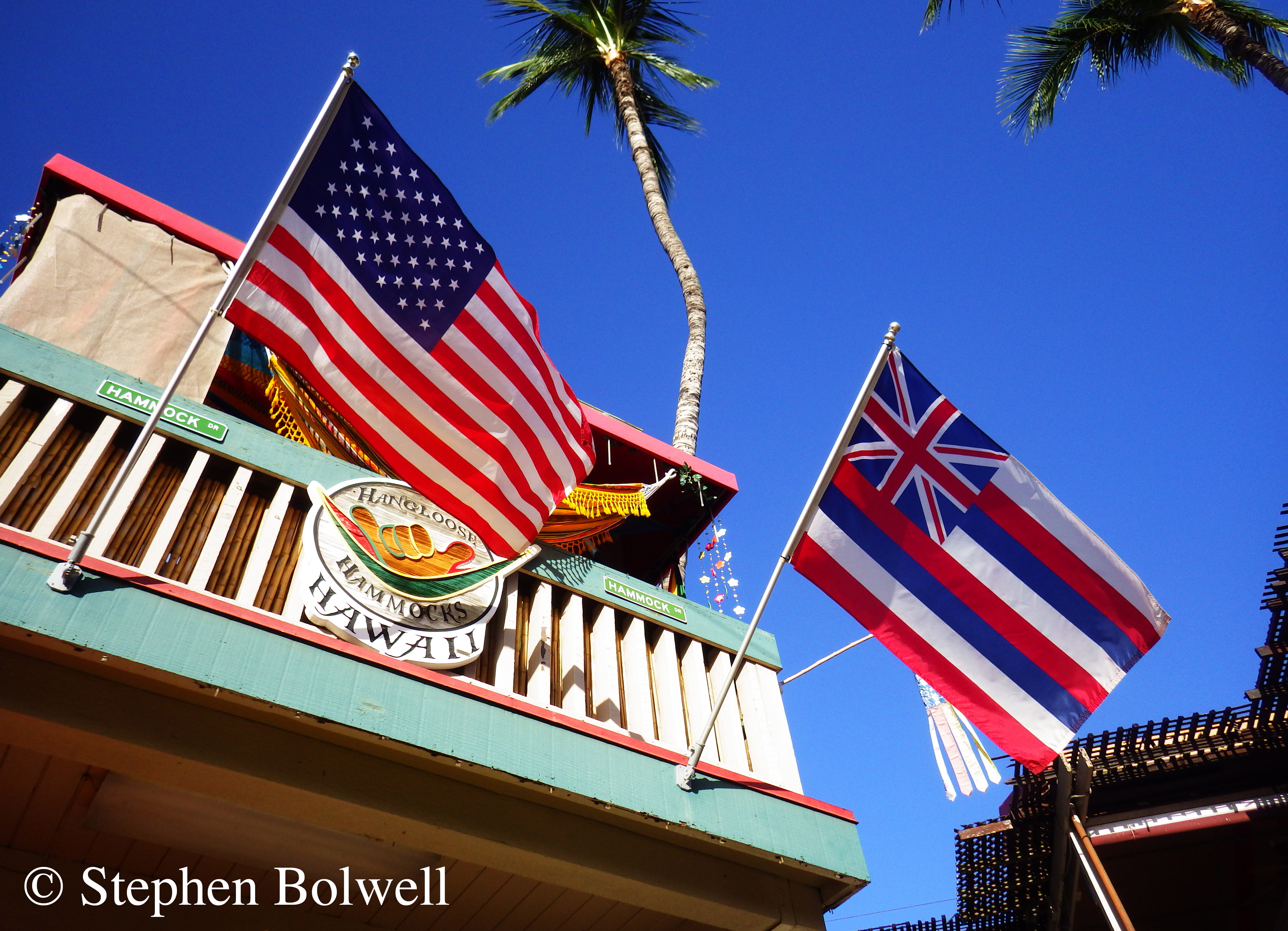 Flags are not traditionally Polynesian; these two flutter beneath an Hawaiian sky as a reminder of the transient nature of colonialism.