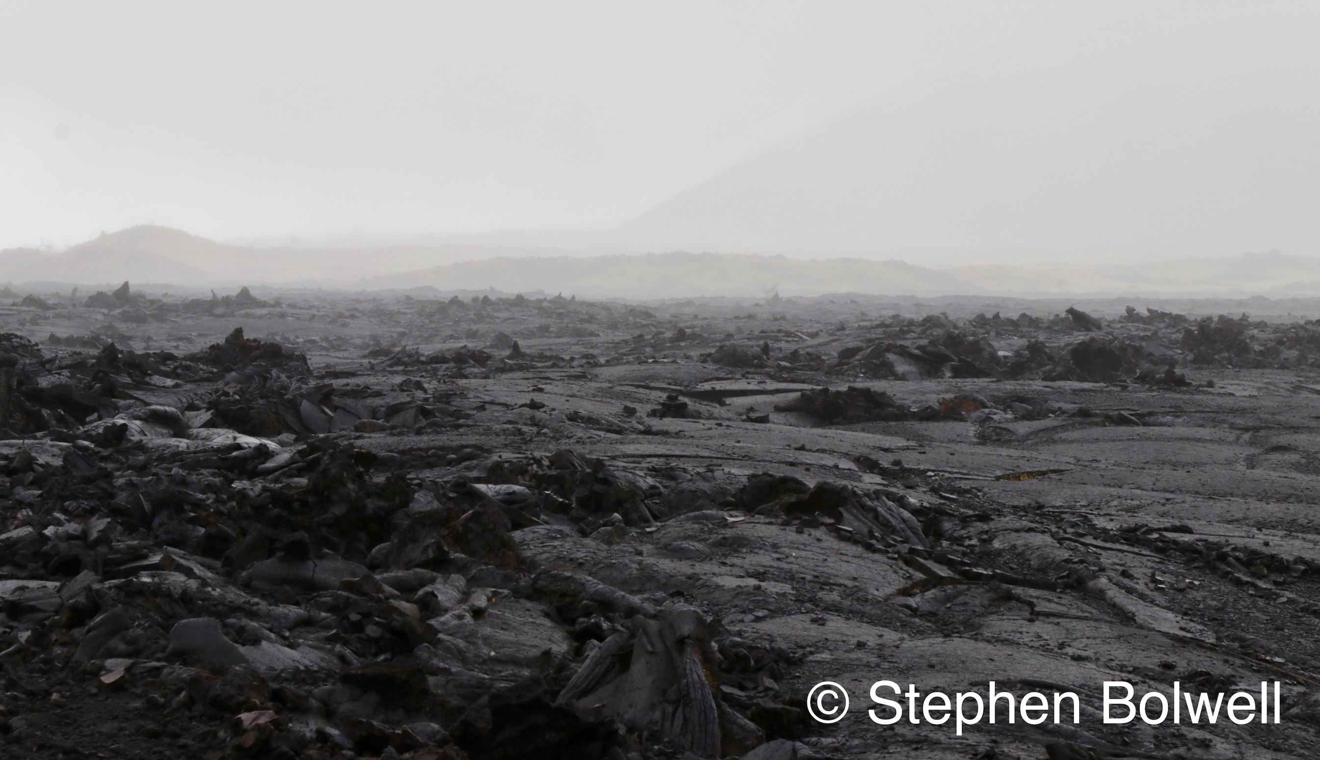 In areas where larva has recently flowed, in this case across land between Mauna Loa and Mauna Kea the landscape sometimes has an unworldy feel and may remain free of vegetation for many years and is largely depending upon altitude and weather conditions.